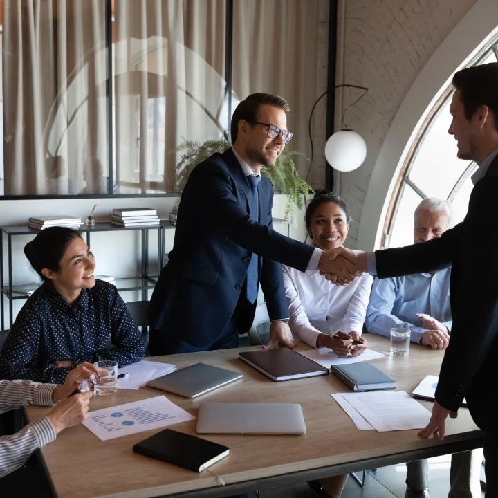 A handshake sealing a deal, symbolizing a successful visa with Immigration Consultants in Kerala.